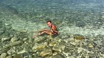 Slender tanned blonde gets fucked on the beach by the sound of waves during a photo shoot