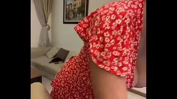 My stepmom is sitting in a red dress and showing her tits