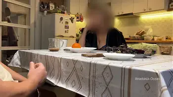 My husband jerking under a table front of my step mom and i right at the kitchen.