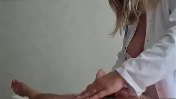 A beautiful masseuse doctor with big tits was surprised when her client's cock got aroused and she saw an erection