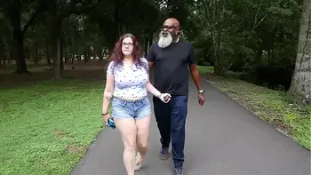 Nerdy Milf strokes and suck blk dick in the Park