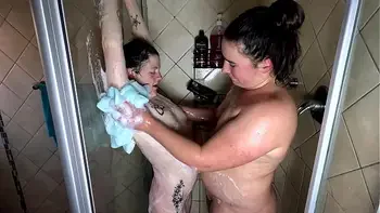 Mature and young lesbians having a pleasurable soapy shower.