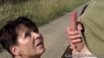 Mature succubus sucks off hung youngster on roadside