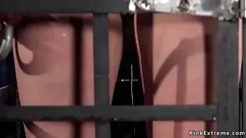 Babe in cage gets water bondage