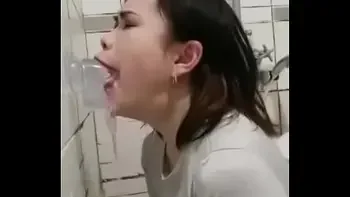 Asian deepthroating a dildo