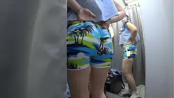 Voyeur in a public shopping center peeps into the changing room for a girl with a beautiful ass. Fetish.