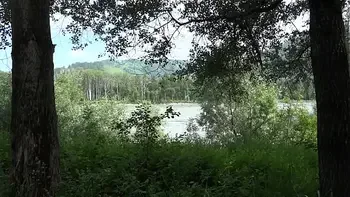 Voyeur outdoors peeps at two naked lesbians. Nudists with big asses sunbathe and enjoy nature and masturbation.