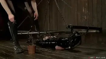 Busty MILF in heavy latex bondage