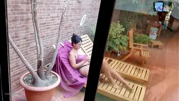 My stepson takes out his big cock on the terrace, gets excited looking at me behind the window and showing his erection to the neighbors. My nipples are very hard and I'm not wearing a bra.