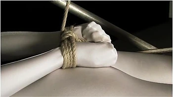 Babe Wrapped In White Zentai Suit Enjoys To Be Bondaged To A Metal Pole
