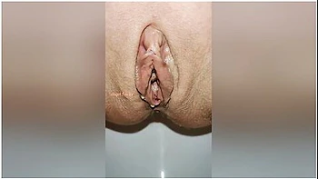 Beautiful Bald Pussy Of Petite Milf Makes The Big Powerful Urine Fountain Close Up