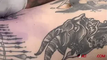 Sascha plays with Amber Luke while she gets tattooed