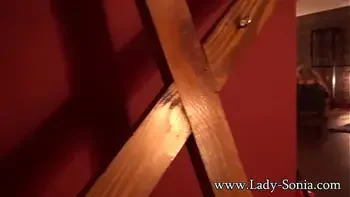 Lady Sonia caged and strips nude in the sex dungeon