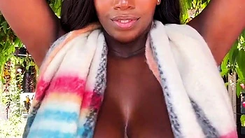 Ebony babe masturbates outdoors with huge tits