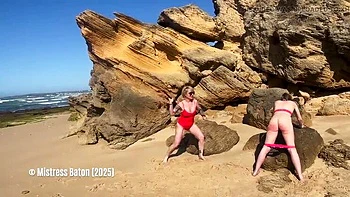 Blonde Mistress Canes Slave in Bikini on Beach