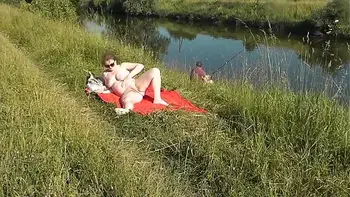 MILF sexy Frina on river bank undressed and sunbathes naked. Random man fisherman watching for her, and in the end decided to join naked woman. Wild beach. Nudist beach. Public nudity. Public exposure. Naked in public